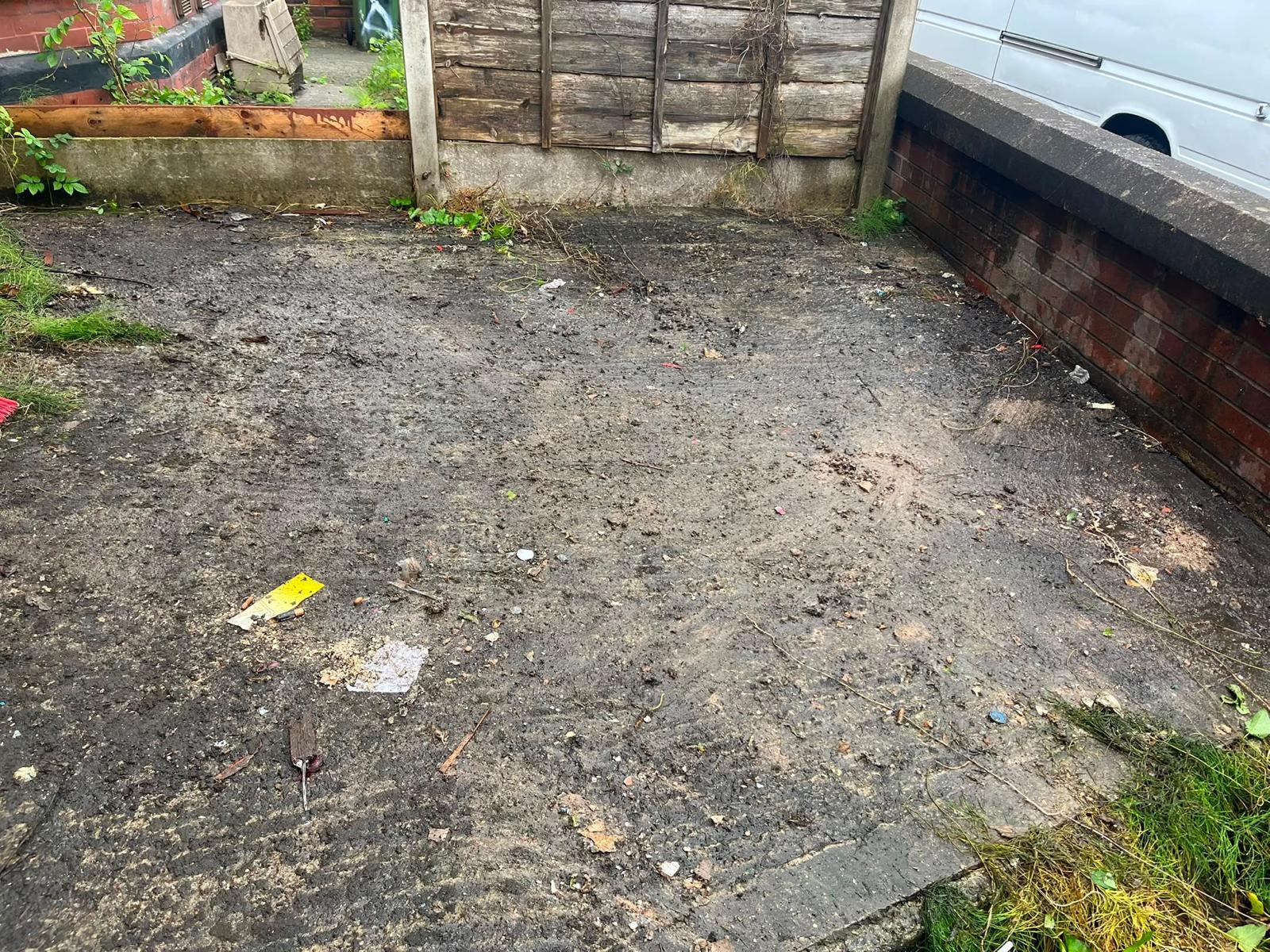 After: the same outdoor yard cleared and tidy, with the brick wall and white van visible.