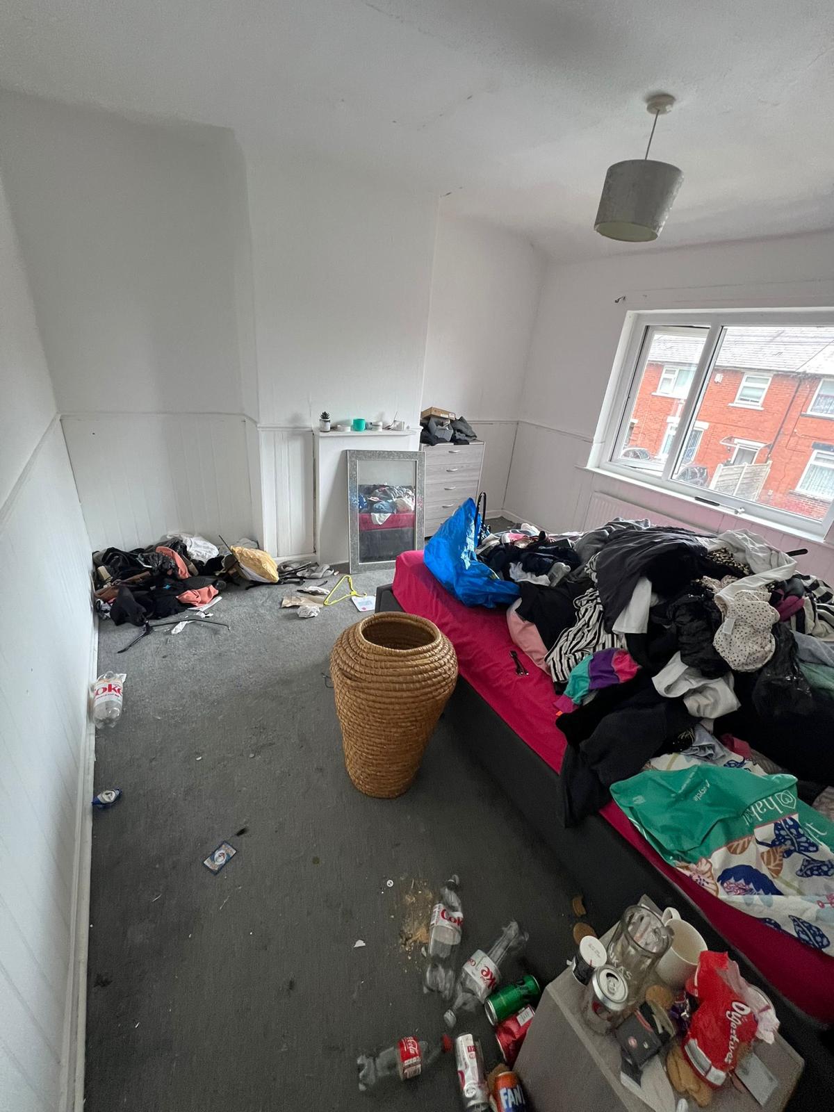 Before: a cluttered bedroom with clothes, bottles, cans and rubbish covering the bed and floor.